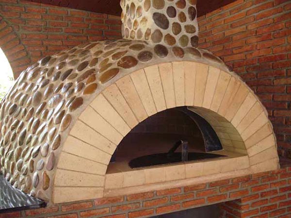 Pizza oven decorated with river stones